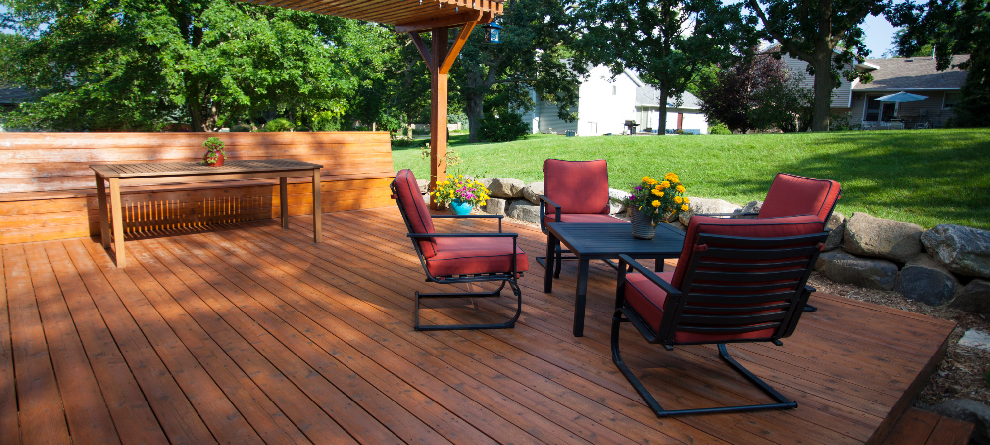 Wooden patio with chairs and a table outside