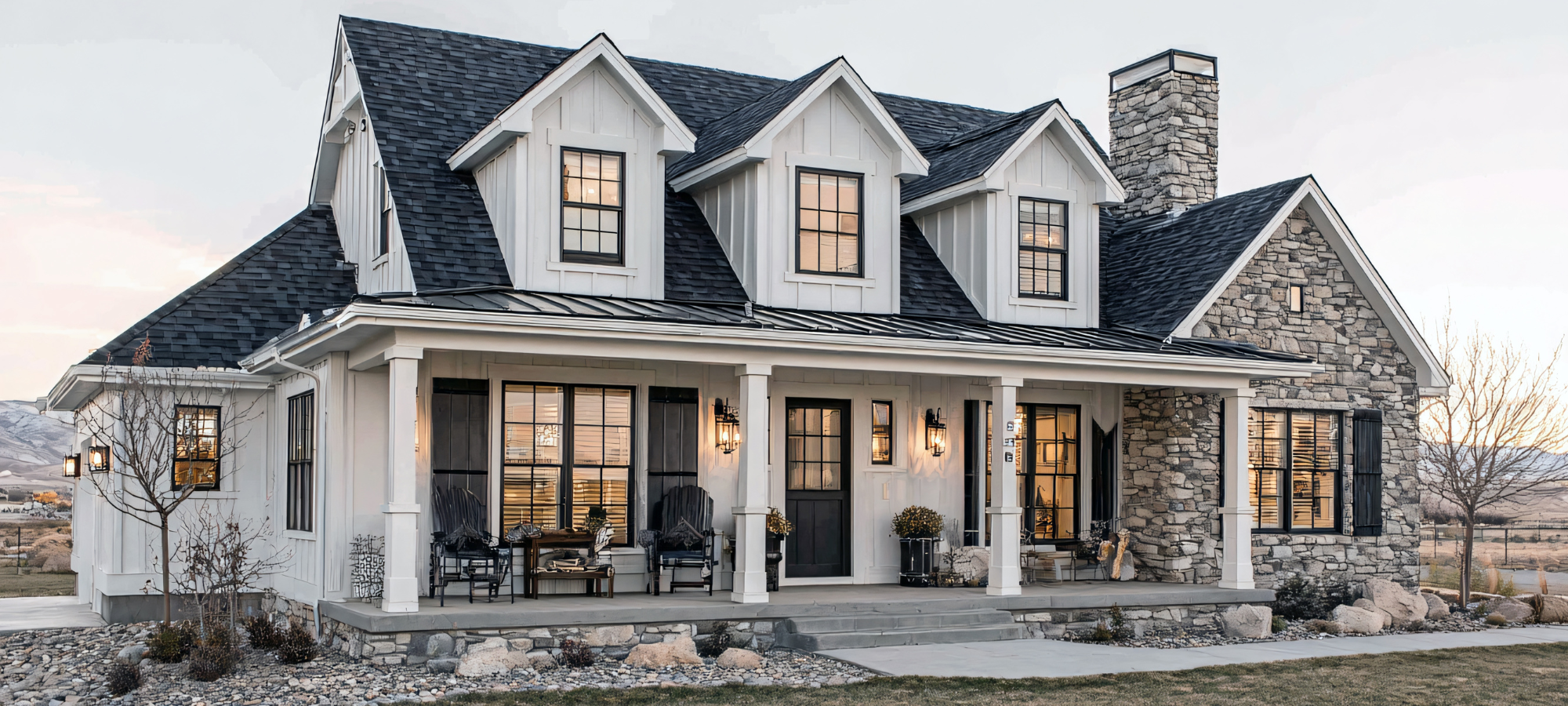 white and black barn inspired home with brick on one side.