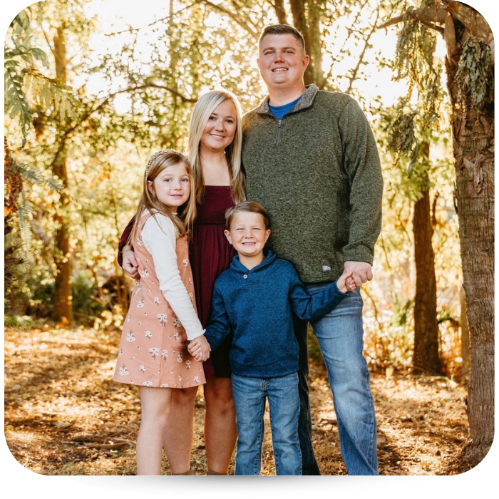 Man and woman with two kids a girl and boy. 